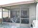 Enclosed patio featuring screened windows and outdoor seating at 1004 Catherine St, Kissimmee, FL 34741
