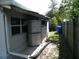 Practical side yard with storage units and a partial view of the house, offering utility and convenience at 1004 Catherine St, Kissimmee, FL 34741