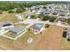 Aerial view of homes in a community with a damaged roof covered in a blue tarp at 1038 Sabine Pl, Kissimmee, FL 34759