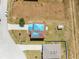 Aerial view of a home with blue tarps on the roof and an empty lot at 1038 Sabine Pl, Kissimmee, FL 34759