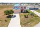 Aerial view of house with new blue roof and well-maintained landscaping at 1038 Sabine Pl, Kissimmee, FL 34759