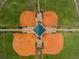 Aerial view of a cross-shaped baseball field layout with covered seating and palm trees at 1038 Sabine Pl, Kissimmee, FL 34759