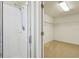 Bathroom with shower featuring white tiles and glass door, adjacent to closet at 1038 Sabine Pl, Kissimmee, FL 34759