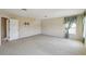 Large, empty bedroom with neutral walls, carpet, and natural light from a window at 1038 Sabine Pl, Kissimmee, FL 34759