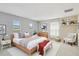 Stylish bedroom with a cozy armchair, bed, and decorative shelves at 1038 Sabine Pl, Kissimmee, FL 34759
