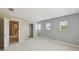 Carpeted bedroom with natural light from three windows and ensuite bathroom at 1038 Sabine Pl, Kissimmee, FL 34759