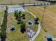 Aerial view of a community dog park with play areas, benches, and walking paths at 1038 Sabine Pl, Kissimmee, FL 34759