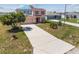Expansive front yard with green grass and mature landscaping for great curb appeal at 1038 Sabine Pl, Kissimmee, FL 34759