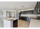 Modern kitchen with stainless steel refrigerator, dark cabinets, and white countertop island at 1038 Sabine Pl, Kissimmee, FL 34759