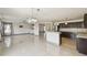 Spacious open-concept kitchen with stainless steel appliances, dark cabinets, and modern pendant lighting at 1038 Sabine Pl, Kissimmee, FL 34759