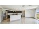Open concept kitchen with stainless steel appliances, dark cabinets, and bright eat-in area at 1038 Sabine Pl, Kissimmee, FL 34759