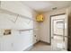 Bright laundry room with shelving for storage and tile flooring, plus bathroom access at 1038 Sabine Pl, Kissimmee, FL 34759
