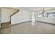 Open living room with tile floors leads to staircase and bright windows at 1038 Sabine Pl, Kissimmee, FL 34759