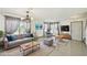 Staged living room boasts tile floors, neutral walls, and ample natural light at 1038 Sabine Pl, Kissimmee, FL 34759