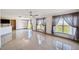 Open living room with tile floors, ceiling fan, and sliding glass doors to the backyard at 1038 Sabine Pl, Kissimmee, FL 34759