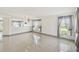 Spacious living room with tile flooring, gray trim, and lots of natural light at 1038 Sabine Pl, Kissimmee, FL 34759