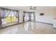 Bright living room featuring large windows with sheer curtains and tile flooring at 1038 Sabine Pl, Kissimmee, FL 34759