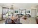 Staged living room features tile floors, a dining table, and neutral walls at 1038 Sabine Pl, Kissimmee, FL 34759