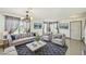 Staged living room boasts tile floors, furniture, decor and ample natural light at 1038 Sabine Pl, Kissimmee, FL 34759