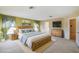Comfortable main bedroom with a king bed, dresser, and television with carpeted floors at 1038 Sabine Pl, Kissimmee, FL 34759