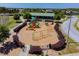 Aerial view of a modern playground with colorful equipment and mature landscaping at 1038 Sabine Pl, Kissimmee, FL 34759