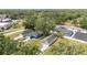 An eye-level aerial view reveals the blue-colored home, complemented by mature landscaping at 108 Pearlwood St, Orlando, FL 32811