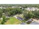 Aerial view of the home on a grassy lot surrounded by trees at 108 Pearlwood St, Orlando, FL 32811