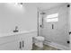 Modern bathroom featuring white vanity, toilet, and a glass-enclosed shower with marble-like tile at 108 Pearlwood St, Orlando, FL 32811