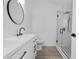 Modern bathroom features stylish black fixtures, sleek vanity, and frameless glass shower at 108 Pearlwood St, Orlando, FL 32811