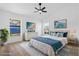 Cozy bedroom featuring a large bed, beach themed wall art, and a bright window at 108 Pearlwood St, Orlando, FL 32811