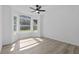 Bright bedroom featuring a ceiling fan, with natural light streaming in from large bay windows at 108 Pearlwood St, Orlando, FL 32811