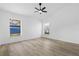 Bright, spacious bedroom has a ceiling fan, wood-look floors, and two windows offering natural light at 108 Pearlwood St, Orlando, FL 32811