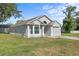 Single-story home featuring a light gray facade and a well-maintained lawn with an attached garage at 108 Pearlwood St, Orlando, FL 32811