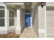 Close-up of the home's entrance featuring a blue front door, white pillar, and textured facade at 108 Pearlwood St, Orlando, FL 32811