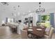 Modern kitchen with white cabinets, stainless steel appliances, island with seating, and adjacent dining area at 108 Pearlwood St, Orlando, FL 32811