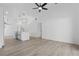 Bright, open-concept living room featuring sleek flooring, white walls, and modern lighting fixtures at 108 Pearlwood St, Orlando, FL 32811