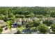 Aerial view of homes in a lush community with mature trees and a pond at 12867 Woodmere Close Dr, Windermere, FL 34786