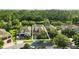 Aerial view of homes in a lush community with mature trees and a pond at 12867 Woodmere Close Dr, Windermere, FL 34786