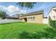 Lush green backyard with fenced perimeter and covered patio, blending indoor/outdoor living at 12867 Woodmere Close Dr, Windermere, FL 34786