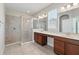 Bathroom featuring dual sinks, updated fixtures, and a large tiled glass enclosed shower at 12867 Woodmere Close Dr, Windermere, FL 34786