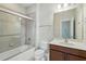 Bathroom featuring a tub and shower combo with grey tile surround and a single sink vanity at 12867 Woodmere Close Dr, Windermere, FL 34786