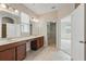 Bathroom with a double vanity, tile flooring, and a view into the walk-in closet at 12867 Woodmere Close Dr, Windermere, FL 34786