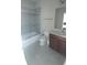 Bathroom featuring a shower-tub combo, and a single sink vanity with tile flooring at 12867 Woodmere Close Dr, Windermere, FL 34786