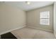 Bedroom with plush carpet, neutral colored walls, and a large window providing natural light at 12867 Woodmere Close Dr, Windermere, FL 34786