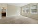 Spacious bedroom featuring neutral walls, carpet floors, and lots of natural light from the large windows at 12867 Woodmere Close Dr, Windermere, FL 34786