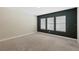 Carpeted bedroom with natural light from the three windows with view of the outdoors at 12867 Woodmere Close Dr, Windermere, FL 34786