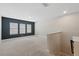 Carpeted bonus room with three windows letting in natural light and a painted accent wall at 12867 Woodmere Close Dr, Windermere, FL 34786