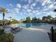 Community pool featuring lounge chairs on the patio and lush tropical landscaping at 12867 Woodmere Close Dr, Windermere, FL 34786