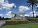 Berkshire Park community entrance sign with an American flag waving in the wind at 12867 Woodmere Close Dr, Windermere, FL 34786