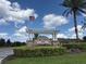 Beautiful Berkshire Park community sign with flag and manicured landscaping welcomes residents at 12867 Woodmere Close Dr, Windermere, FL 34786